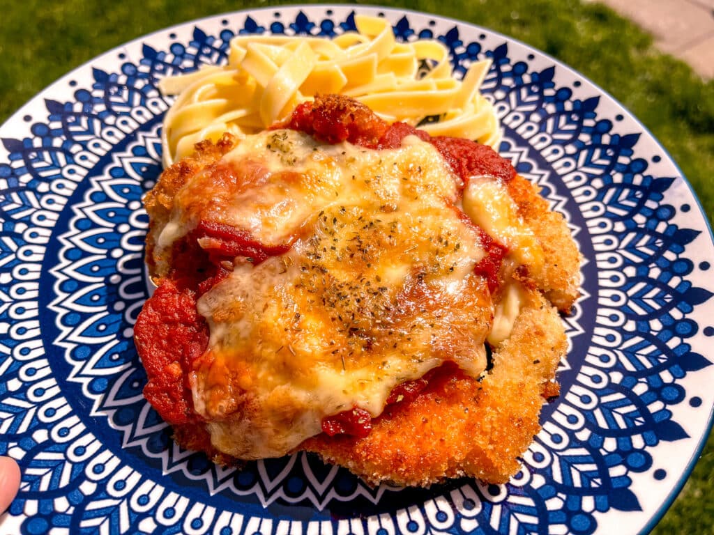 best chicken parmesan on a blue plate