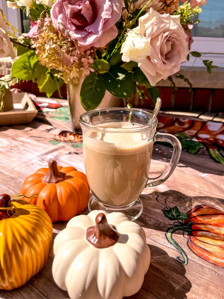 pumpkin spice latte whipped dalgona with pumpkins around it decorating