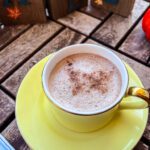 brazilian cappuccino yellow cup and fall decor in background