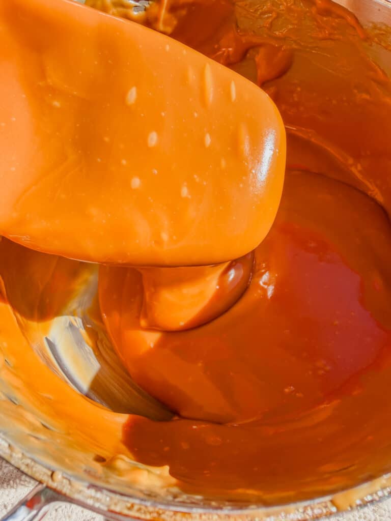 dulce de leche dropping from spoon