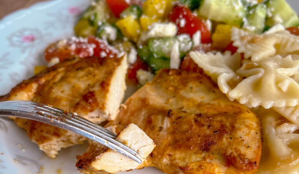 juciy chicken breast pierced by fork