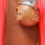 sweet potatoe chocolate ice cream being scooped out of red container