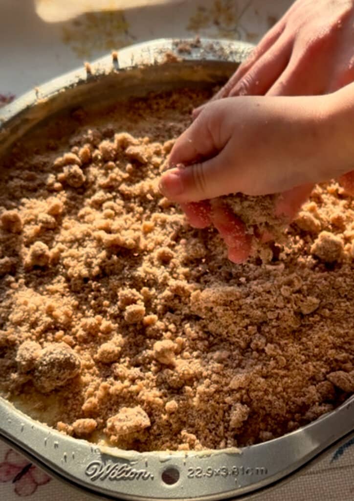 adding crumble to the cake