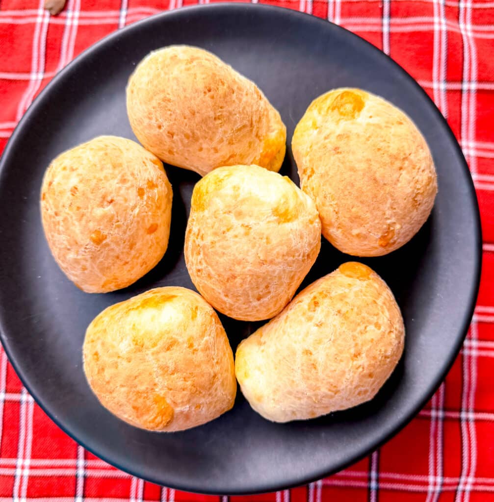 large pao de queijo brazilian cheese bread on black plate