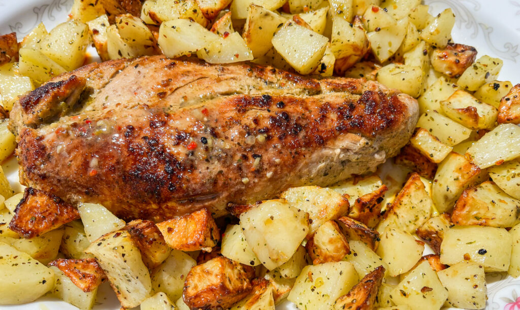 5 ingredient pork tenderloin served with roasted potatoes.