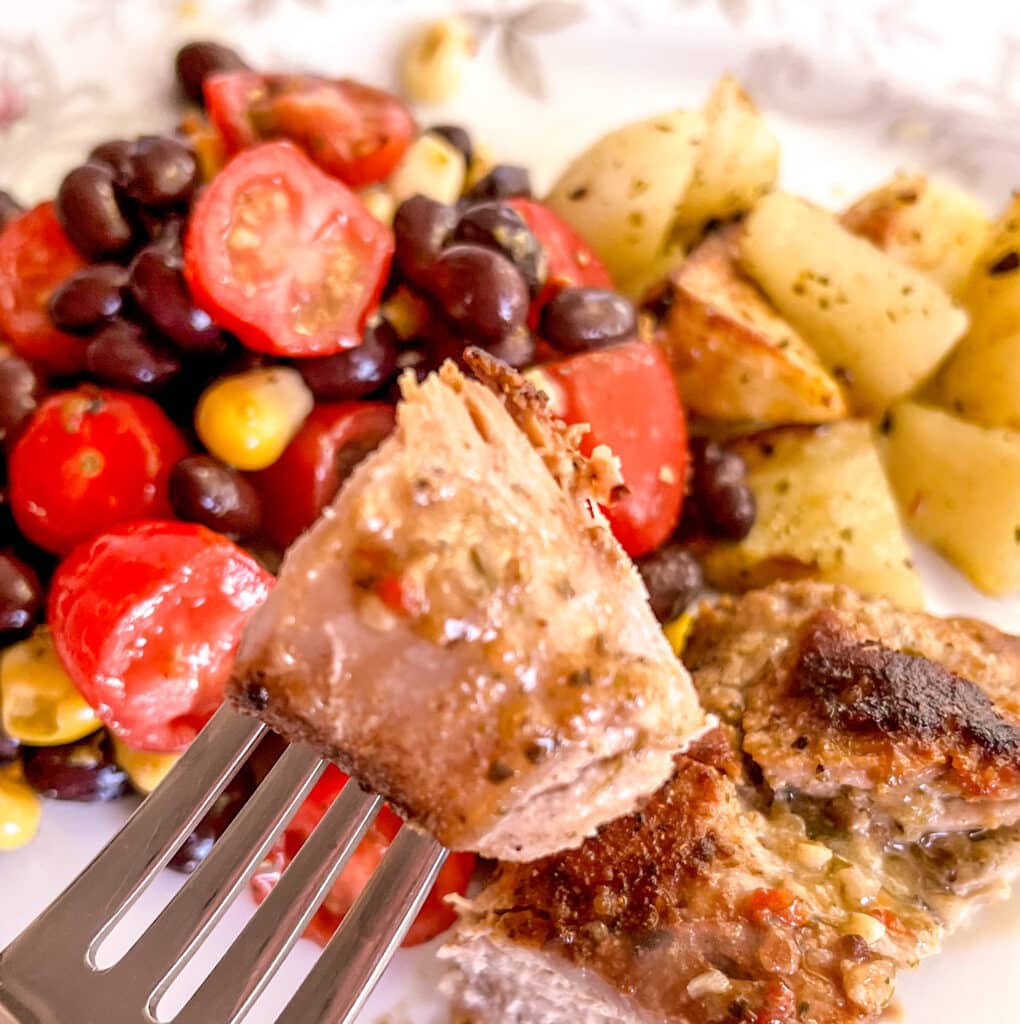 pierced piece of 5 ingredient pork tenderloin by a fork
