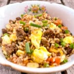 Easy Ground Beef Fried Rice in a bowl with a single flower