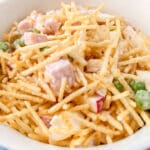 Brazilian Salpicao Chirstmas Salad with batata palha in a white bowl