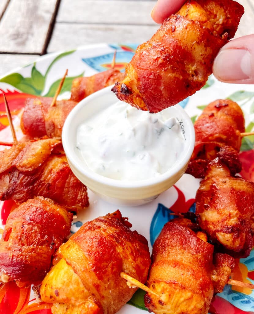 bacon wrapped chicken bites served with yogurt sauce on the side