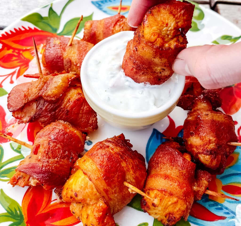 dipping bacon wrapped chicken bites served with in tangy yogurt sauce