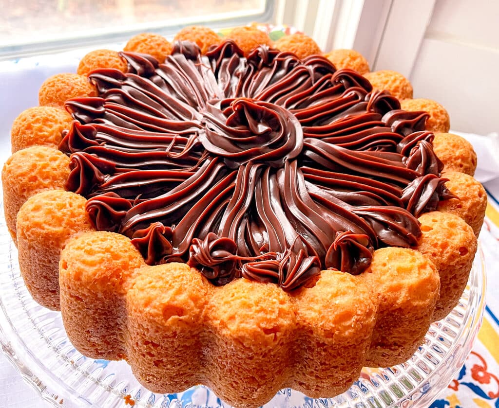 carrot cake with brigadeiro frosting near window