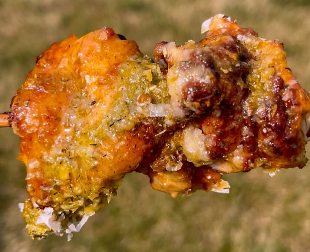 up close shot of chicken thigh skewer with pesto