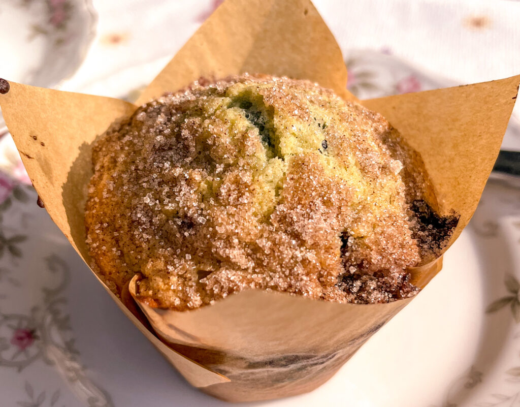 close-up Fresh blueberry muffin wrapped in a tulip liner with golden, domed top