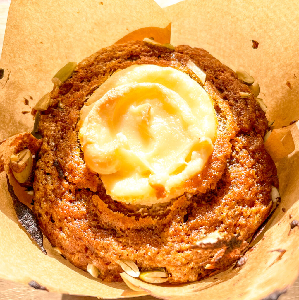 up close shot of pumpkin muffin with cream cheese