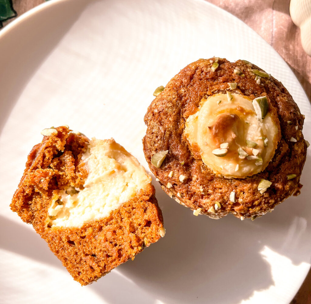 sliced version of pumpkin muffin with cream cheese filling close up