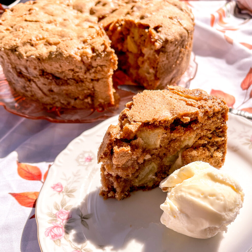 Apple cake served with ice cream with cake and tea on the background