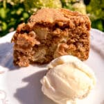 apple cake slice served with ice cream flowers on the background