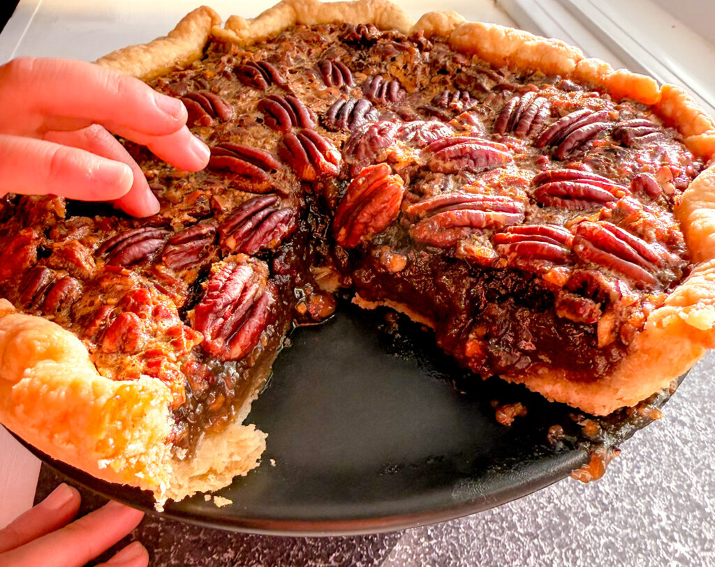 pecan pie with toddler hands on top