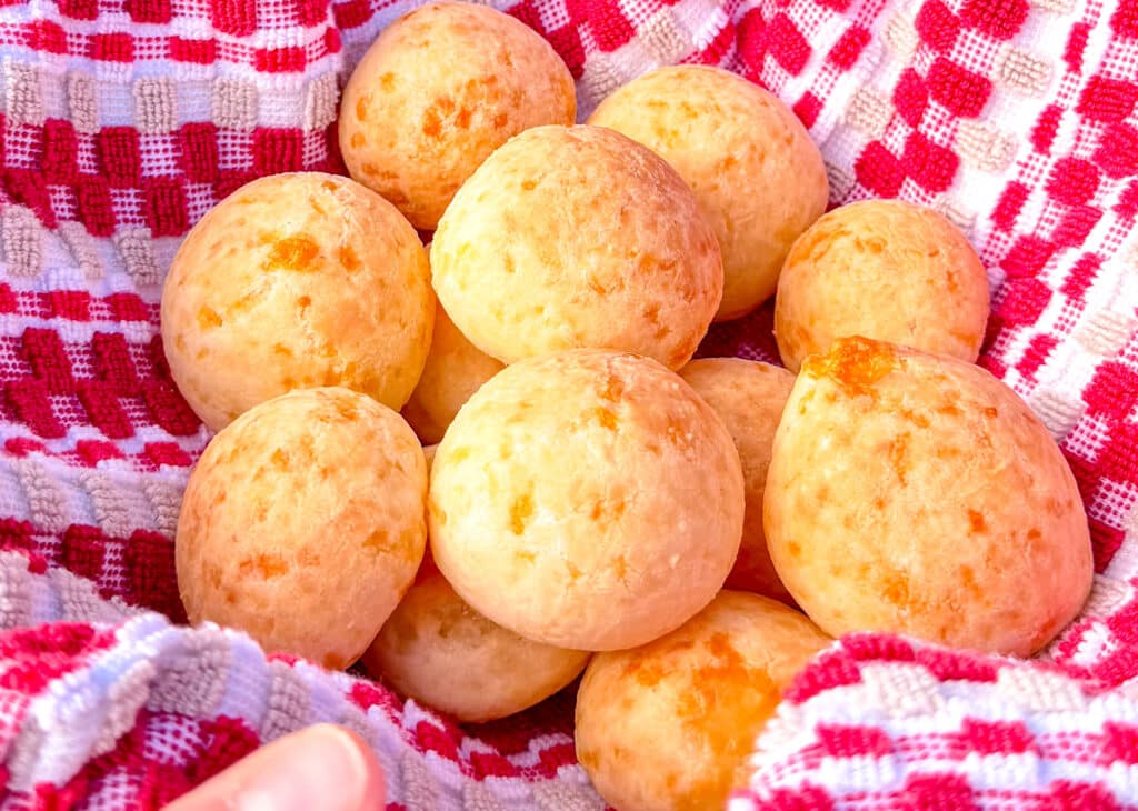 pao de queijo, brazilian cheese bread on a  red and white checkered towel