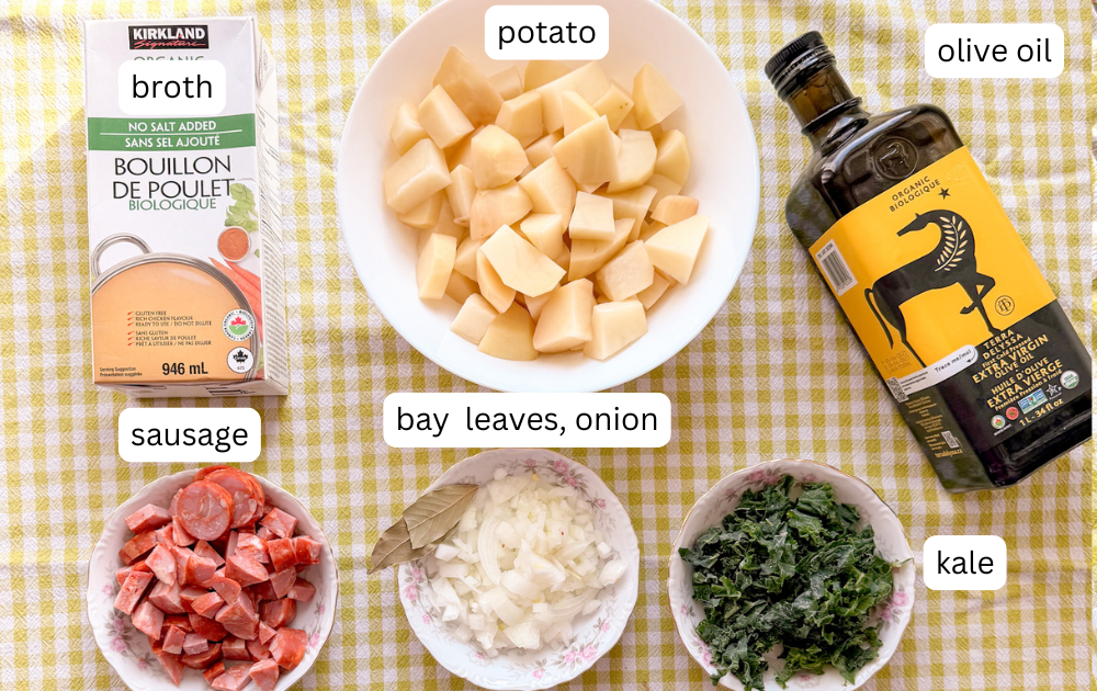 ingredients for caldo verde soup displayed on a tables with checkered tablecoth