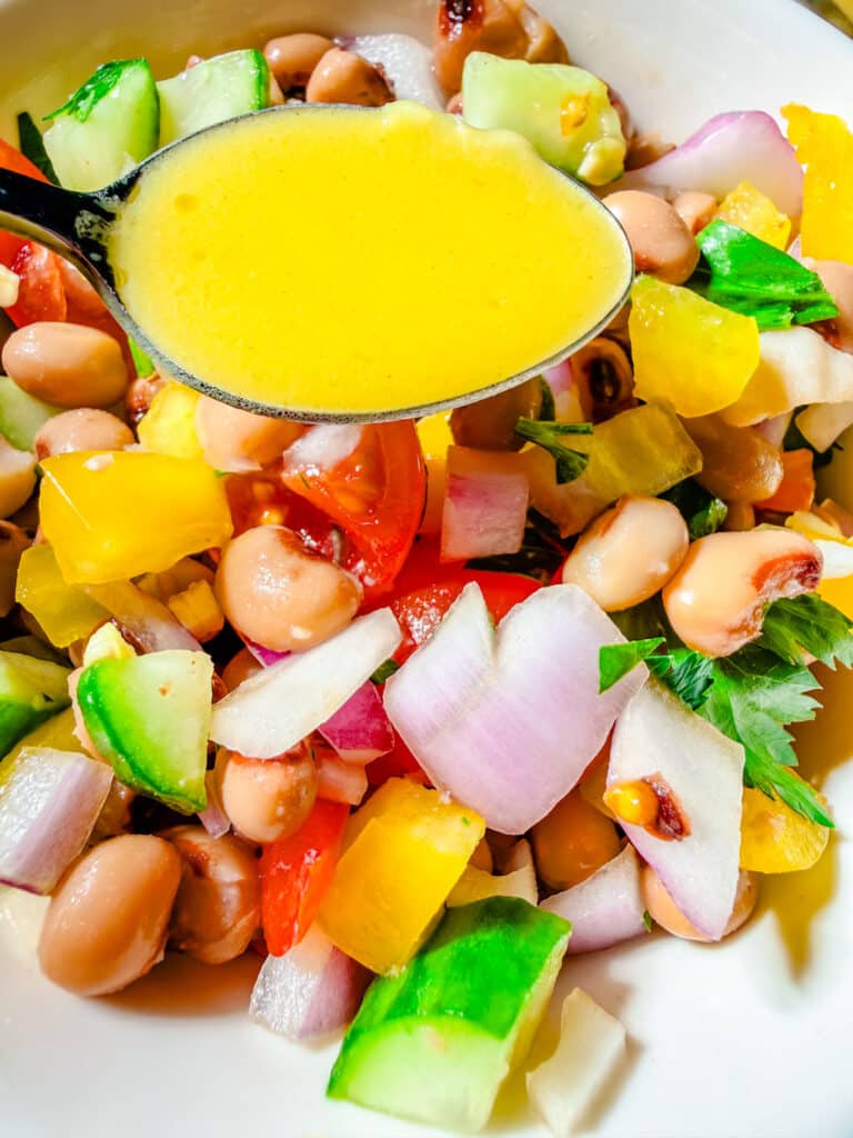black eyed pea salad with honey mustard dressing in a bowl