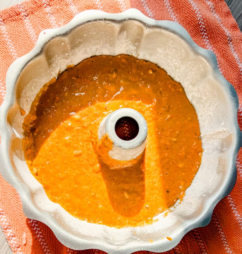 bundt pan with carrot cake batter ready to bake
