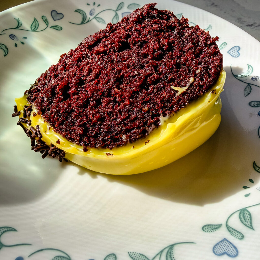 Close-up of fluffy chocolate cake with smooth white chocolate brigadeiro frosting