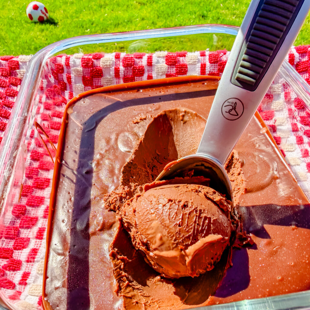 scooping chocolate truffle ice cream with soccer ball in the background