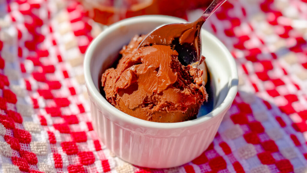 up close shot of chocolate truffle ice cream in a white ramekin