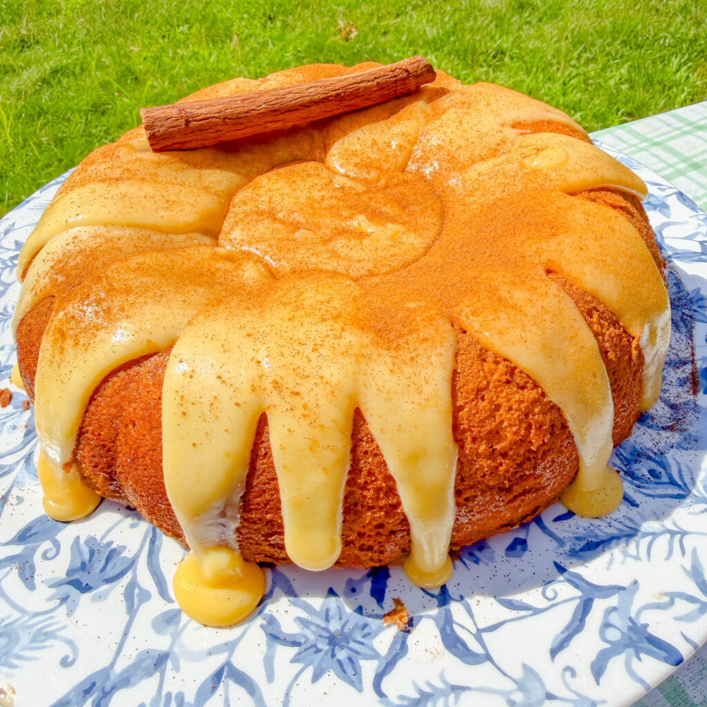 Homemade Brazilian corn cake with silky corn brigadeiro frosting dripping over a Bundt cake.
