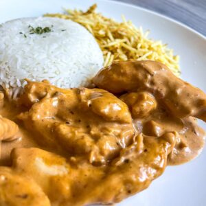chicken stroganof served with white rice an potatoes